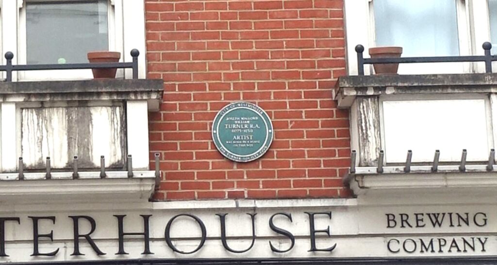 Zoom in of the green plaque on the wall of the porterhouse. Vaguely readable of "Turner R.A (1775-1851). Artist"