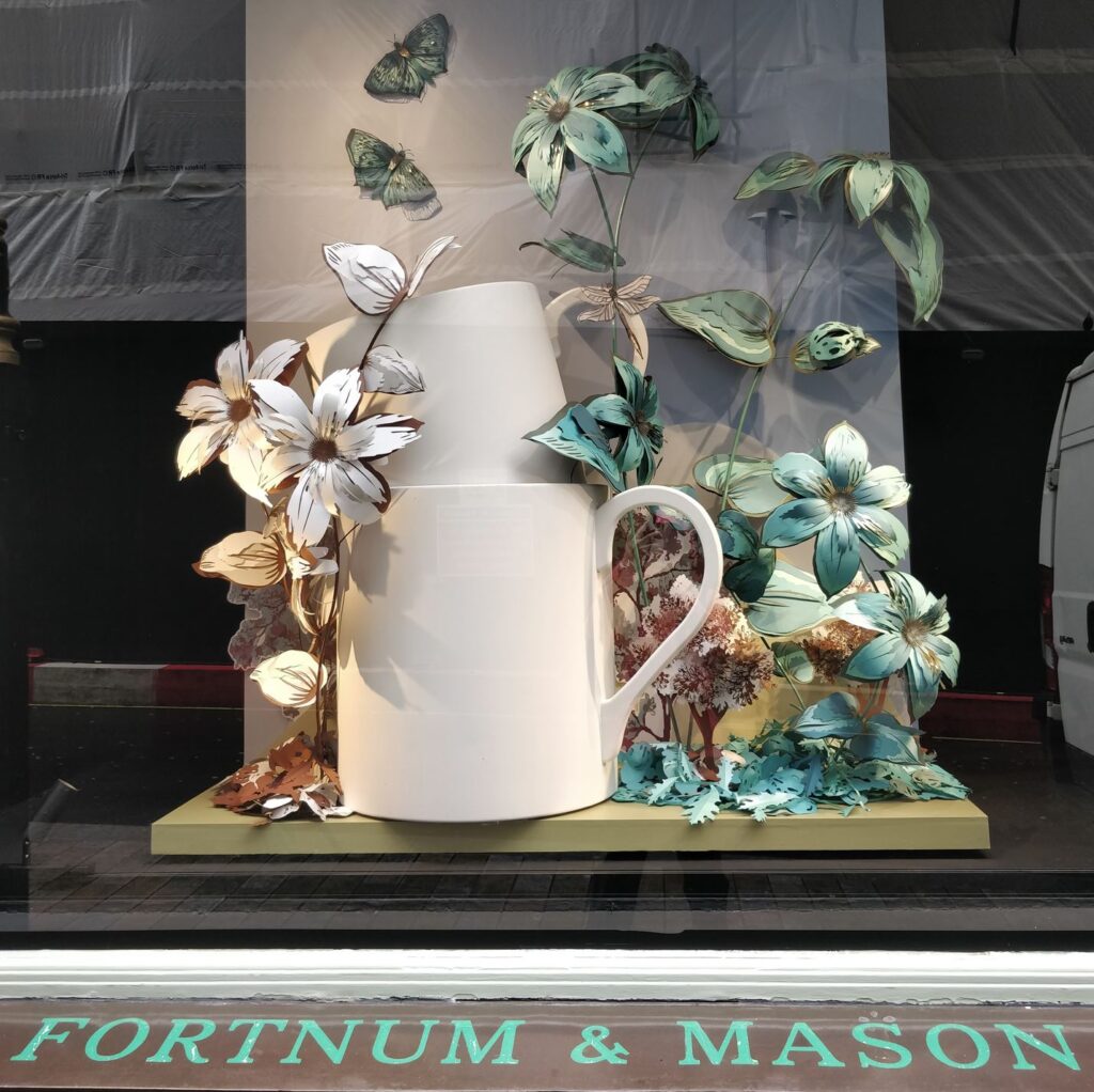 Fortnum and Mason window display: Beautiful white and green flowers with butterflies at the back