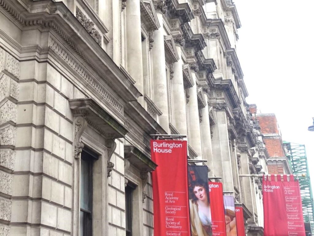 Burlington house facade with red flags